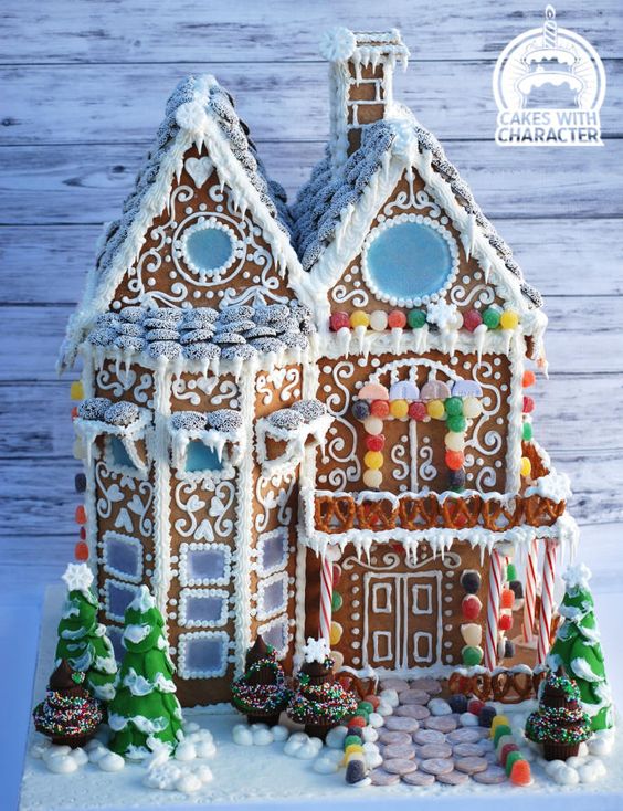 professionally designed gingerbread house with detailed frosting decor.