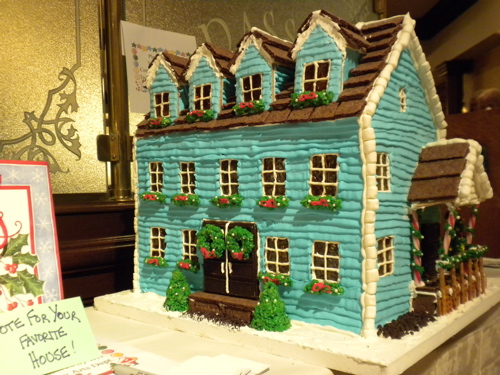 two story large gingerbread house with porch.