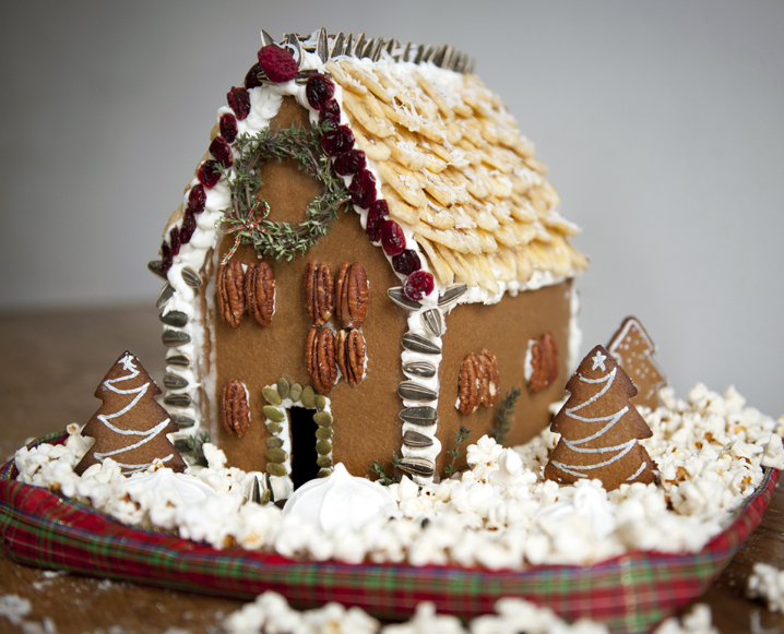 pecan gingerbread house with rosemary tree wreath decoration. 
