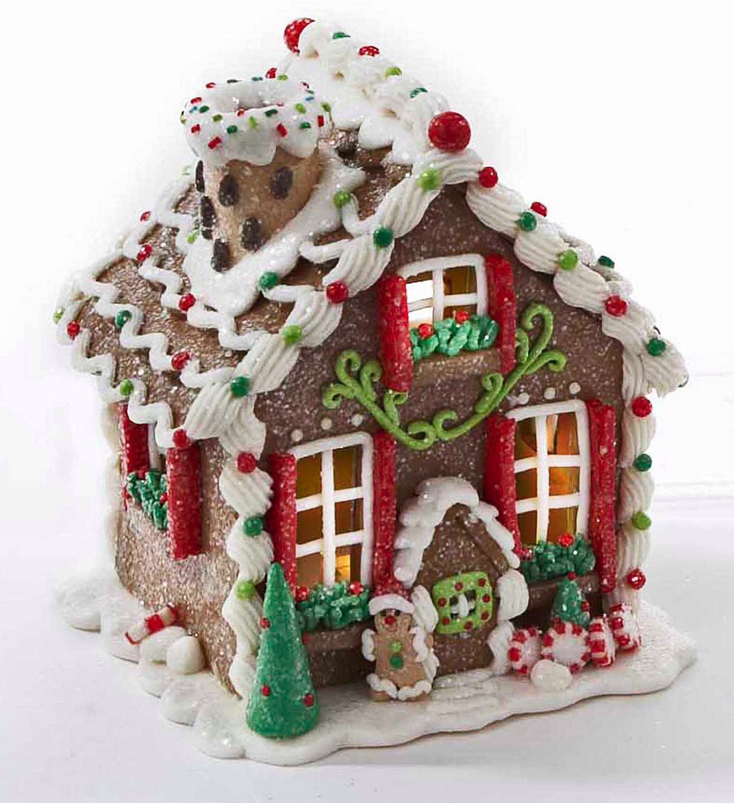 sugar encrusted gingerbread house with frosting decoration. 