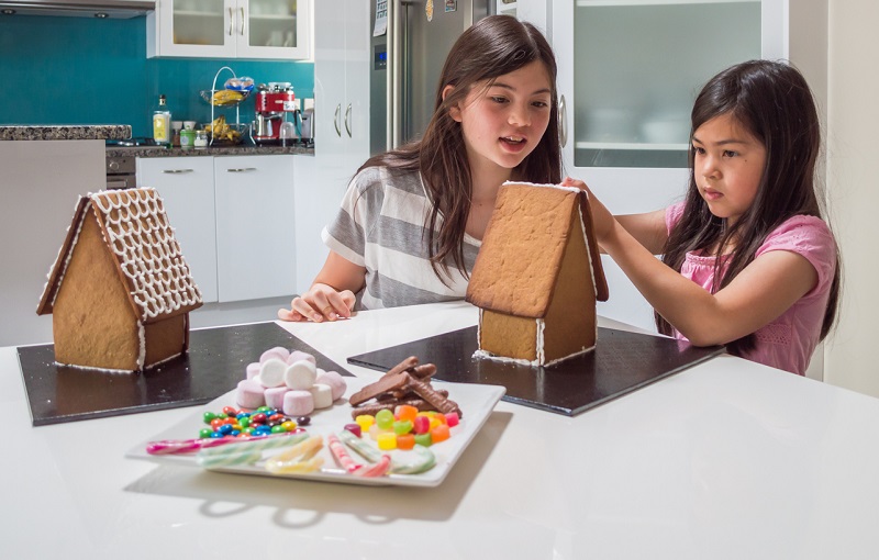 kids building gingerbread houses.