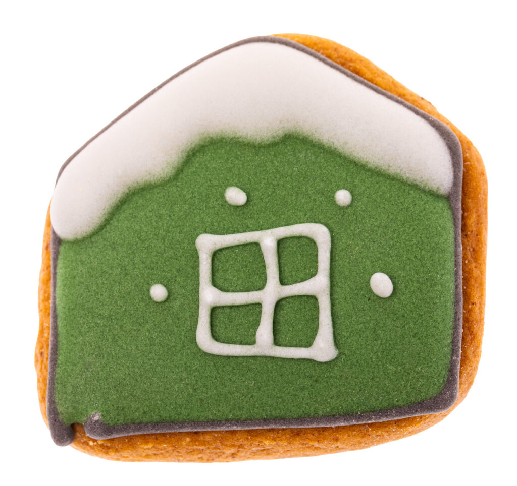 flat gingerbread house cookie flooded with solid dark green icing and a white piped window, isolated on white