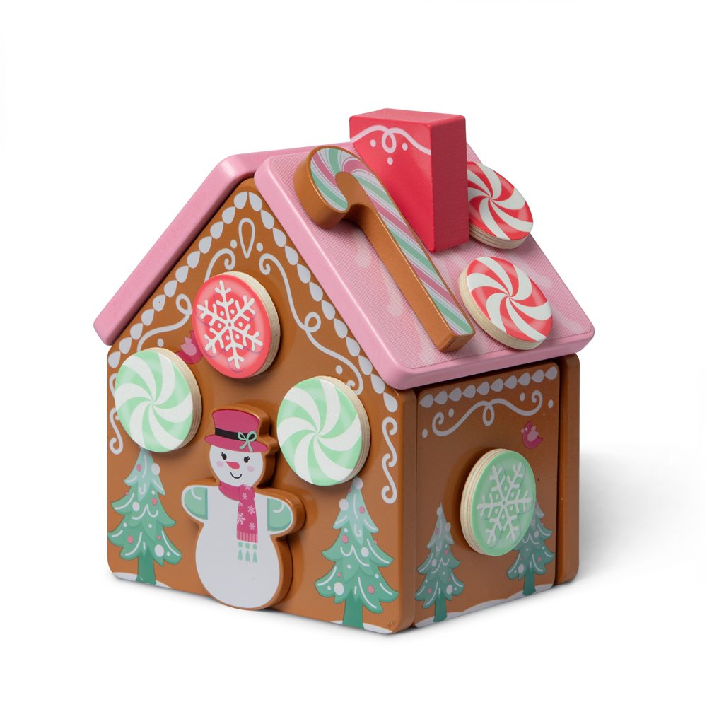 Melissa and Doug classic wooden gingerbread house with brown walls, a pink roof, peppermint candies, a candy cane and a snowman decoration