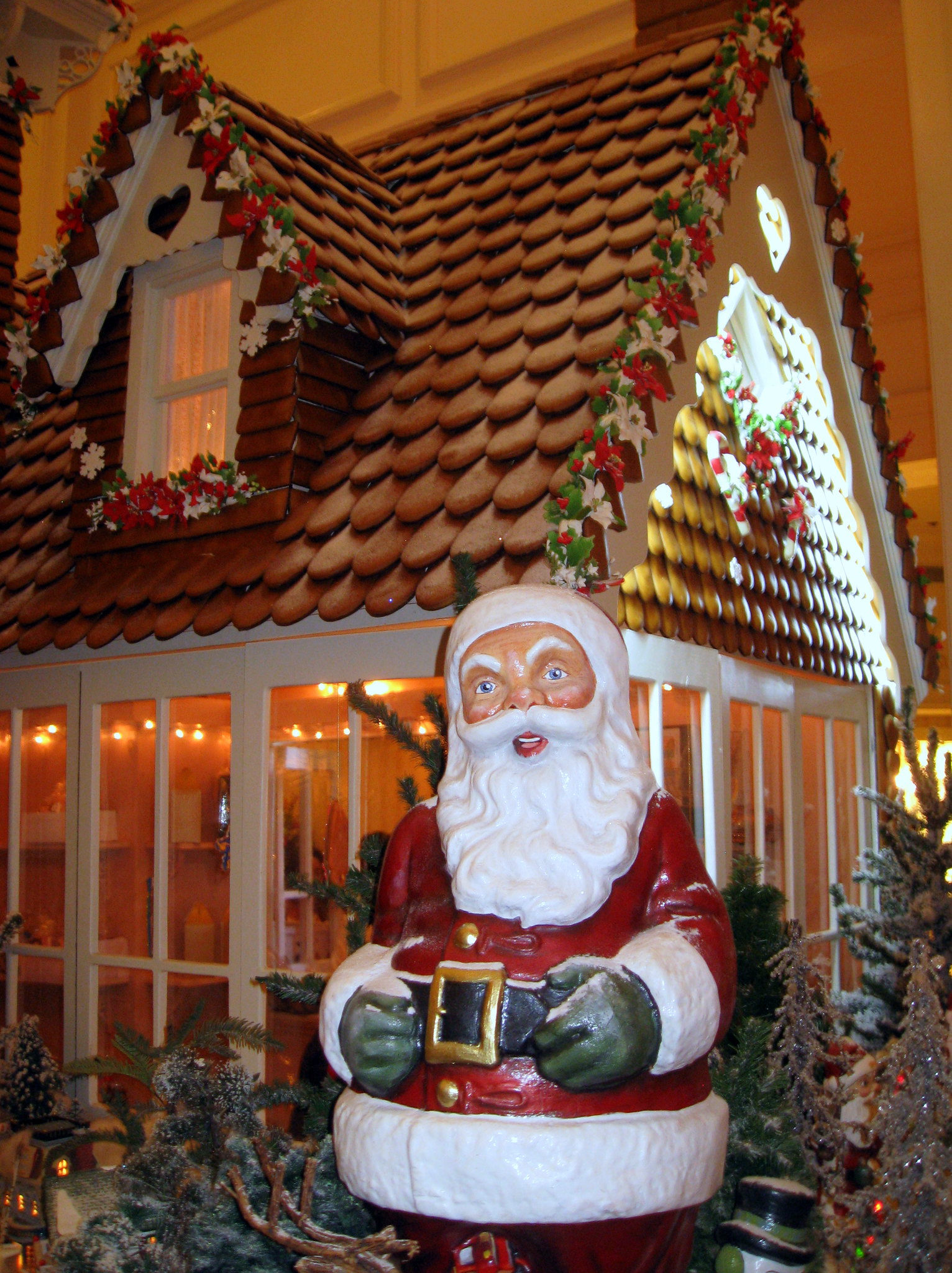 Close-up of the Grand Floridian gingerbread roof with overlapping cookie shingles and red and white garland trim