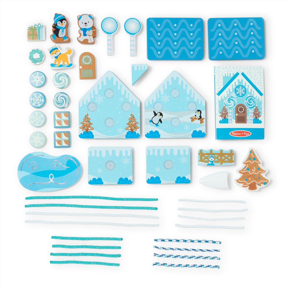 every piece of the Melissa and Doug Winter Frost gingerbread house set laid flat, with blue house panels, wooden candies, animal figures, a pond and sixteen icing cords